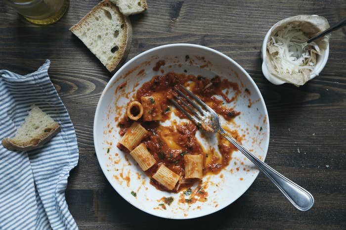 Pasta with tomato sauce partially eaten in a bowl